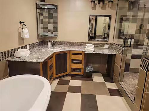 a bathroom with a toilet and two sinks and a shower at A Gorgeous Mansion for Jasper Vacation in Hinton