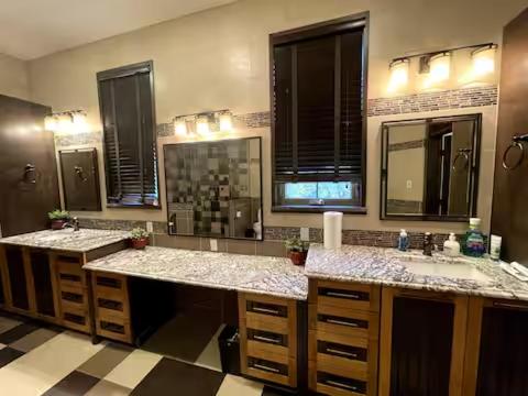 a bathroom with two sinks and two mirrors at A Gorgeous Mansion for Jasper Vacation in Hinton