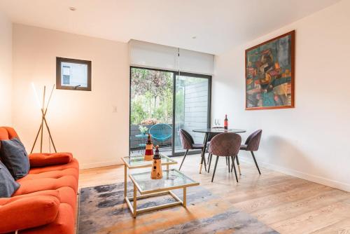 a living room with a couch and a table at Insurgentes Area APT Balcony, Outdoor Lounge in Mexico City