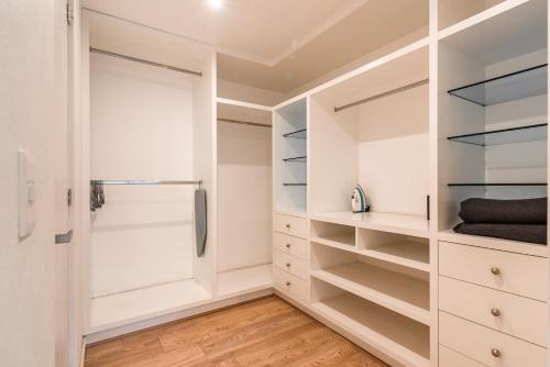 a walk in closet with white cabinets and a refrigerator at Insurgentes Area APT Balcony, Outdoor Lounge in Mexico City