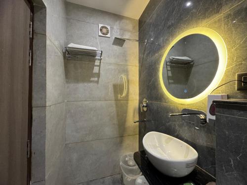 a bathroom with a sink and a mirror at C2 Hotel in Mathura