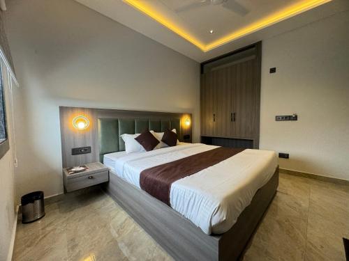 a bedroom with a large bed in a room at C2 Hotel in Mathura