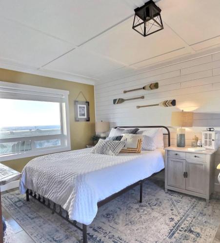 a bedroom with a large bed and a window at Tide Pool Town Home, Entire House, Amazing Views! in Moclips