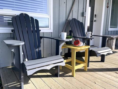 two chairs and a table on a porch at Tide Pool Town Home, Entire House, Amazing Views! in Moclips