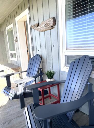two blue chairs and a table on a porch at Tide Pool Town Home, Entire House, Amazing Views! in Moclips