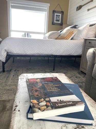 a book sitting on a coffee table next to a bed at Tide Pool Town Home, Entire House, Amazing Views! in Moclips