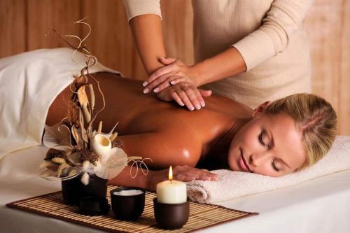 a woman getting a massage in a bed at Chic and Cosy Newly renovated Near the Beach in St Petersburg