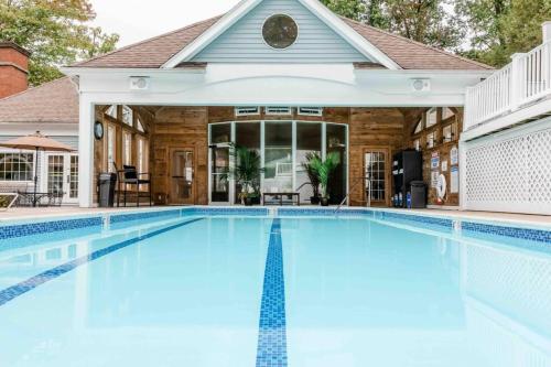 a swimming pool in front of a house at Villa Signor in Norwich