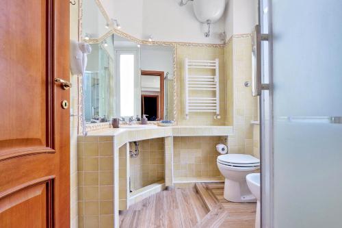 a bathroom with a toilet and a sink and a mirror at Terrazze Navona in Rome
