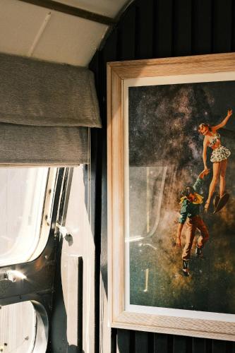 a painting of a man and a woman on a skateboard at Silver Bullet Airstream, El Mistico Glamping Ranch in Nogal