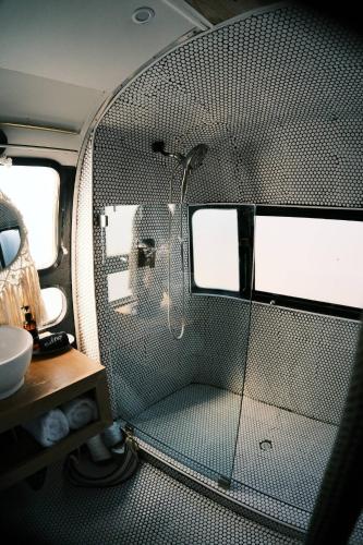 a small bathroom with a shower in an airplane at Silver Bullet Airstream, El Mistico Glamping Ranch in Nogal