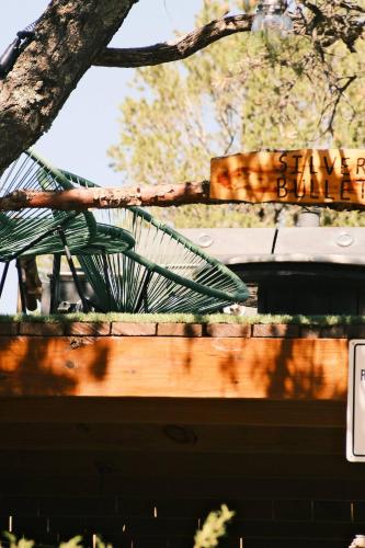 a wooden fence with a tree in the background at Silver Bullet Airstream, El Mistico Glamping Ranch in Nogal