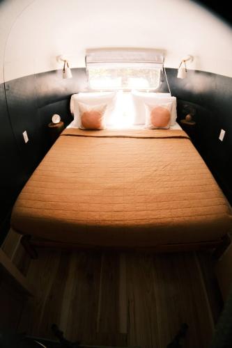 a bedroom with a bed in a small room at Silver Bullet Airstream, El Mistico Glamping Ranch in Nogal
