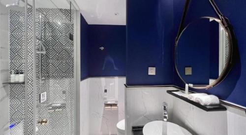 a bathroom with a toilet and a shower with a mirror at Jinjiang Metropolo Shanghai Minhang in Shanghai