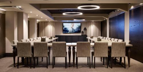 a conference room with a long table and chairs at Lapland Hotels Bulevardi in Helsinki