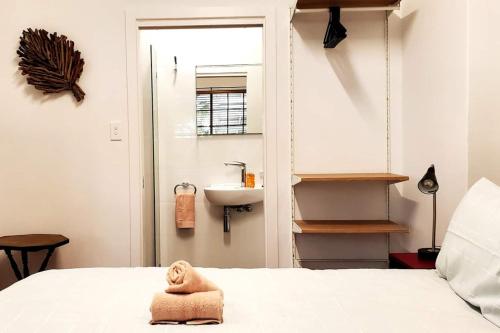 a bathroom with a sink and a bed in a room at Coastal Breeze 2Bedrm 2Bath Pool & Slide in Perth