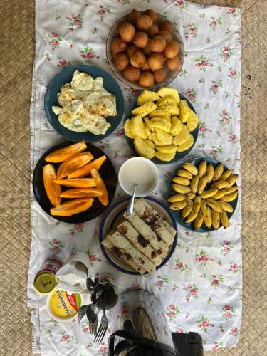 a table topped with plates of food and snacks at Classic Fijian Home 