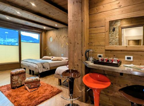 a bedroom with a bed and a sink in a room at Chalet DCB in Bormio