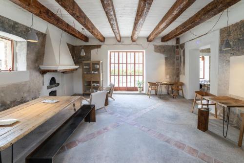 a large room with a table and a fireplace at Vento Forte - eco dimore nel borgo in Civita
