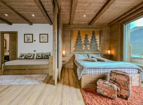 a bedroom with two beds in a log cabin at Chalet DCB in Bormio