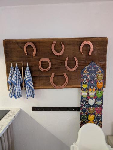 a rack of horseshoes and ties on a wall at Drängstugan in Kolbäck