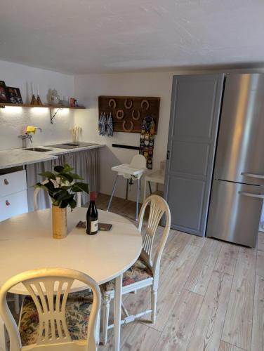 a kitchen with a table and chairs and a refrigerator at Drängstugan in Kolbäck