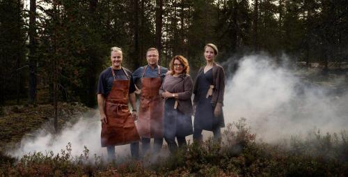 a group of people wearing aprons standing in a field at Lapland Hotels Bulevardi in Helsinki