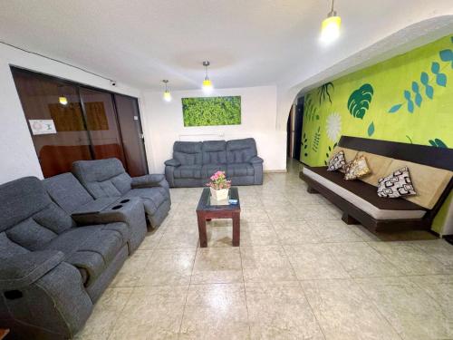 a large living room with couches and a table at Casita del Árbol in Mexico City