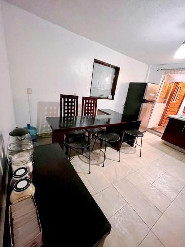 a living room with a dining room table and chairs at Casita del Árbol in Mexico City