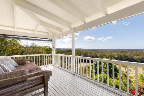 a porch with a bench and a view at Amara Estate in Eumundi