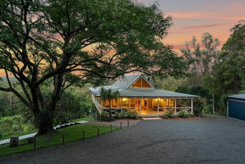 a house with a tree in front of it at Amara Estate in Eumundi