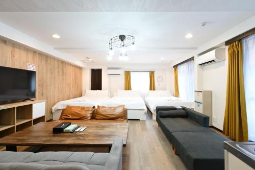 a living room with two beds and a couch at Shinjuku family apartment in Tokyo