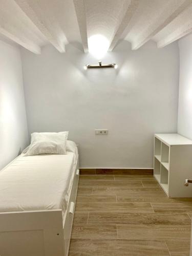 a bedroom with a bed and a light on the ceiling at Apartamento a un minuto de la playa HORT in Villajoyosa