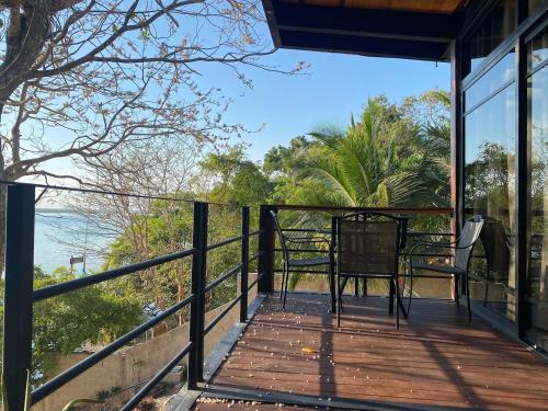 a balcony with a table and chairs on it at Casa Villa Real- Lagoon Acces And Stunning Views! in Bacalar