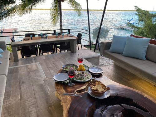 a table with food and drinks on a patio at Casa Villa Real- Lagoon Acces And Stunning Views! in Bacalar