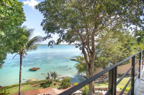 a view of the ocean from a balcony at Casa Villa Real- Lagoon Acces And Stunning Views! in Bacalar