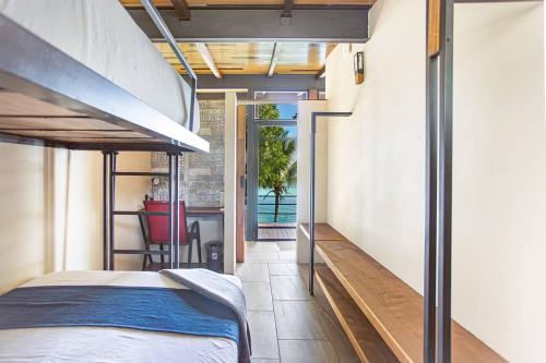 a bedroom with a bunk bed and a balcony at Casa Villa Real- Lagoon Acces And Stunning Views! in Bacalar