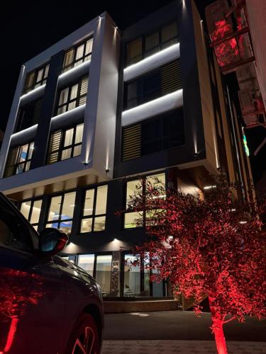 a building with a car parked in front of it at Hotel Spa Olive in Mostar