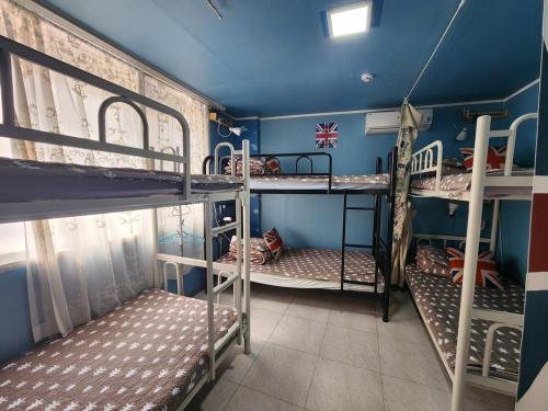 a room with three bunk beds in it at Daegu Glens Guesthouse in Daegu