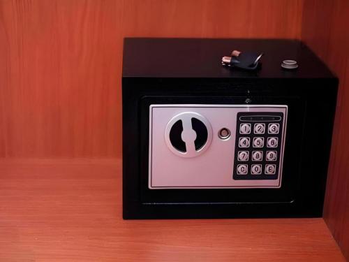 a black and white microwave with a cup on it at Rest@Ratchada hotel in Bangkok