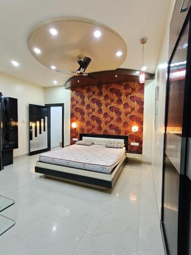 a bedroom with a bed and a brick wall at 3BHK Spacious Villa in Pune