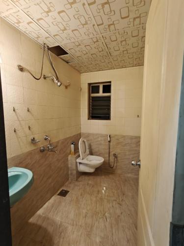 a bathroom with a toilet and a sink at 3BHK Spacious Villa in Pune