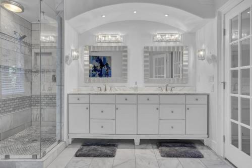 a white bathroom with two sinks and a shower at Stunning 6BR Buckhead OasisPrivate BathEachRoom in Atlanta