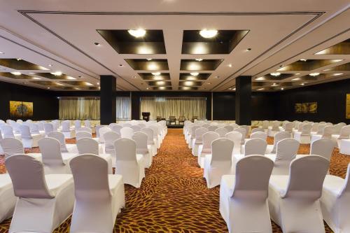 a conference room with white chairs and a stage at Hyatt Regency Dar es Salaam, The Kilimanjaro in Dar es Salaam