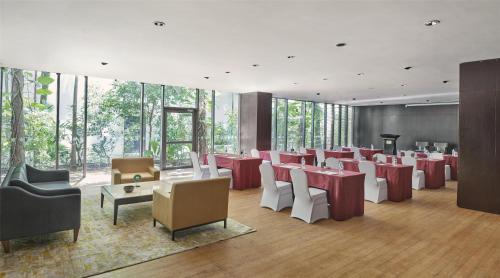 a restaurant with red and white tables and chairs at Hyatt Regency Dar es Salaam, The Kilimanjaro in Dar es Salaam