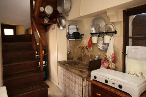 a kitchen with a sink and a counter with pots and pans at Casa Pracol in Combai