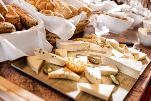 a tray of cheese and bread on a table at Johannesbad Hotel Palace - Kinder bis 11 kostenfrei in Bad Hofgastein
