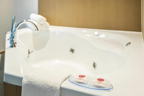a white bathroom sink with two towels on it at Comfort Inn & Suites in Barrie