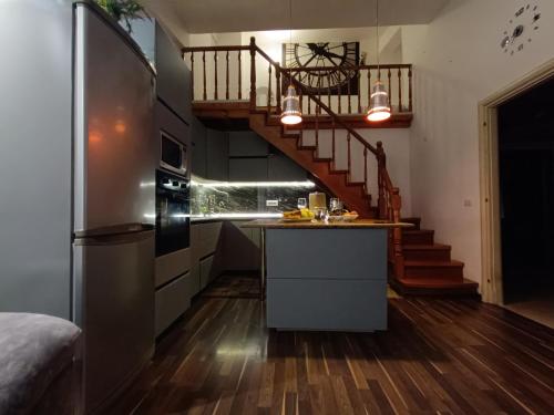 a kitchen with a refrigerator and a staircase at Noah's Seaside in Golem