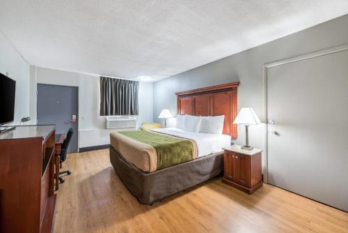 a hotel room with a bed and a desk at Rodeway Inn in Saint Joseph